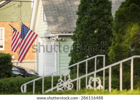 An American home proudly displaying their flag.