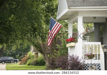 An American home proudly displaying their flag for a patriotic holiday.