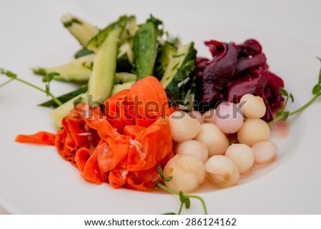 Vegetable salad on a white plate. Restaurant