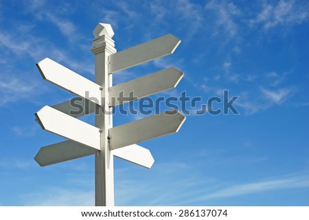 direction sign with blank spaces for text on beautiful sky background Royalty-Free Stock Photo #286137074
