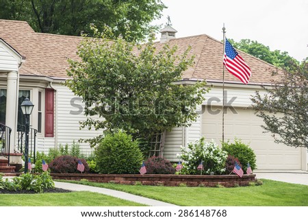 An American home proudly displaying the flag.