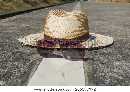 straw hat and sunglasses on the floor