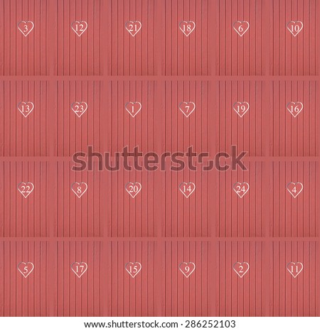 Red hearts calendar doors. Wood wall with red hearts numbered 1-24 in no order for Christmas calendar background or backdrop. 