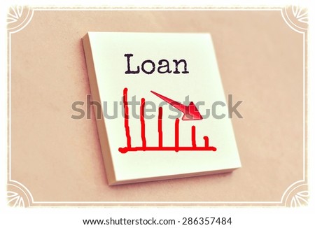 Text loan on the graph goes down on the short note texture background