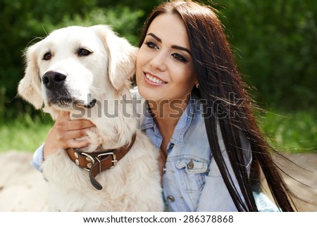Girl on nature with a dog
