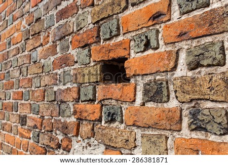 The wall of different color ancient bricks.