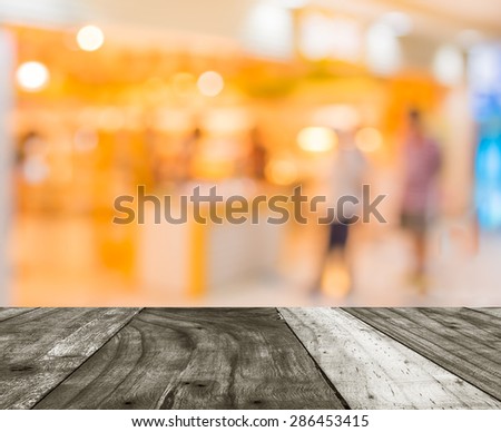 blurred image of shopping mall and people.