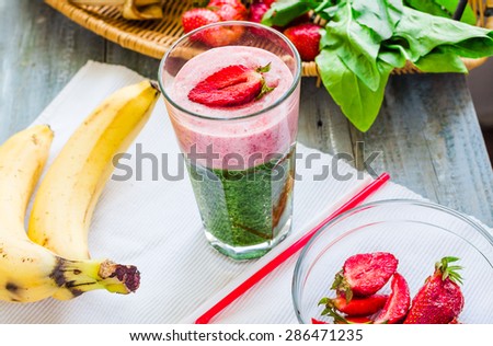 double smoothies, green with spinach, kiwi and banana with strawberries, healthy breakfast, clean eating Royalty-Free Stock Photo #286471235