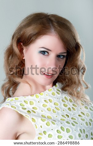 Young woman portrait over light blue grey background