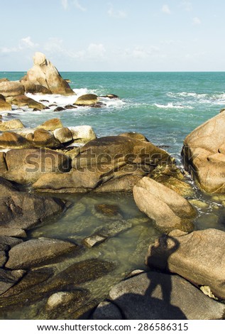 beautiful view of coastline, sea waves and man silhouette on the rocks. summer travel adventure