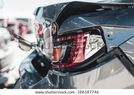 Crashed car in dismantling yard. Royalty-Free Stock Photo #286587746