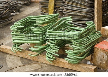 Stacks of green steel re-bar bent in the shape of a U at a construction site in new york city