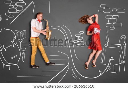 Love story concept of a romantic couple against chalk drawings background. Male playing the sax in a restaurant for his girlfriend.