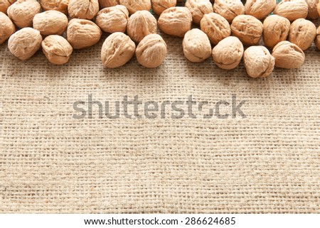 Walnuts overhead view pouch of jute illuminated with natural light