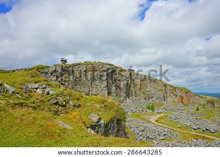 A panorama view of the Cheesewring and its quarry with blue sky and clouds, Bodmin Moor near the Minions, Cornwall, United Kingdom