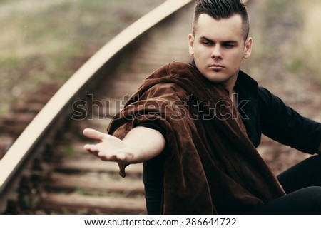 a young man with outstretched hand