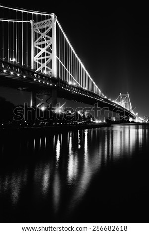 Black and white photo of the Benjamin Franklin Bridge at night, in Philadelphia, Pennsylvania.
