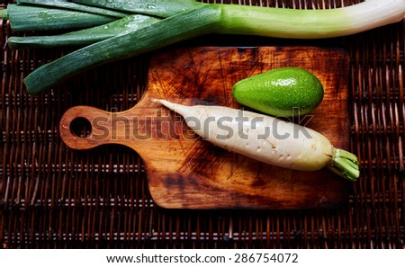 Horseradish and avocado and leek on the vintage table, creative picture of fresh veggies