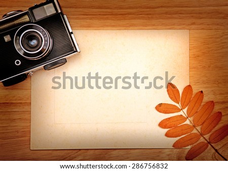 Toned Photo of Old Camera and Empty Paper for Text or Image
