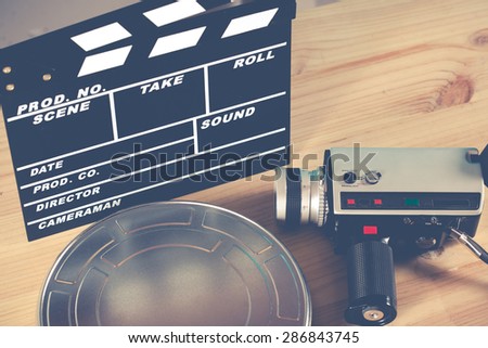 Clapperboard with his camera and tape virgin
