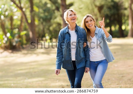 attractive senior mother with daughter relaxing outdoors