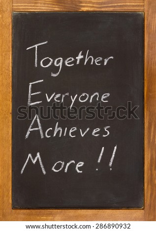 Small chalkboard with a wooden frame with together everyone achieves more written on it in white chalk.