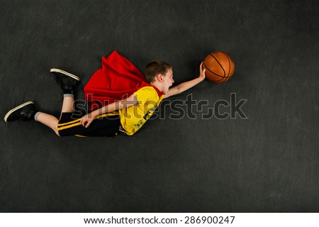 Boy superhero with a basketball Royalty-Free Stock Photo #286900247
