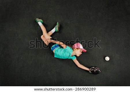 Girl diving for a great baseball catch