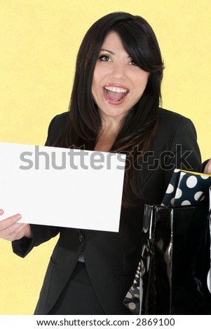 Happy woman holding a sign and bags
