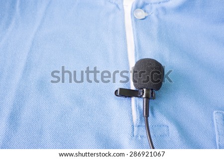 Close-up of  holding a Wireless lavalier microphone