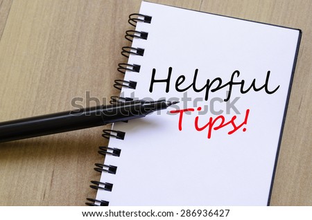 White notepad and ink pen on the wooden desk Helpful tips concept