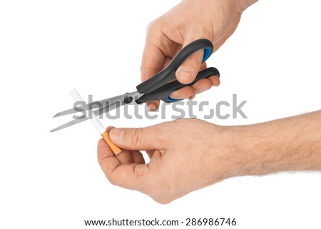 Hand with scissors and cigarette isolated on white background