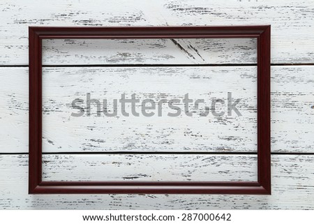 Wooden frame on white wooden background