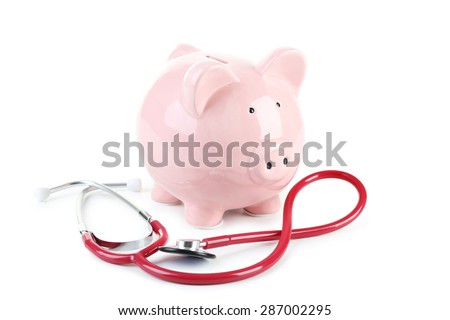 Pink piggy bank with stethoscope isolated on a white