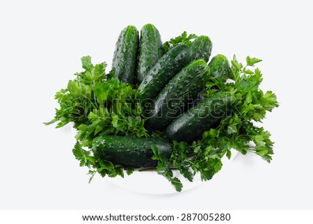 cucumbers with parsley on the plate isolated on white background