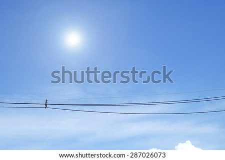 Blue sky with clouds and sun, wire