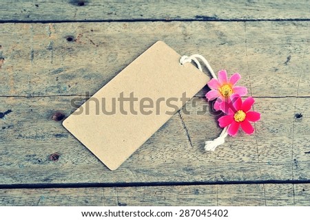 Vintage of the blank price tag label on wooden background.
