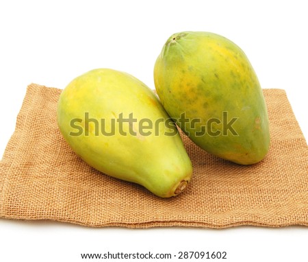 Fresh and tasty papaya on burlap sack on white background 