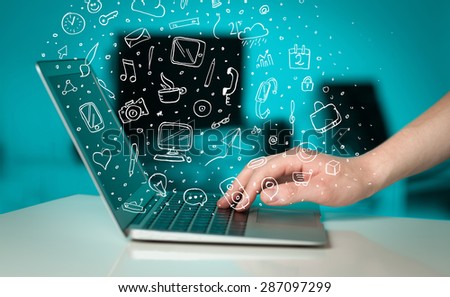 Laptop computer with hand drawn icons and symbols comming out