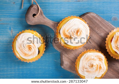 Mini lime curd tartlets with meringue. Holiday concept. Top view.