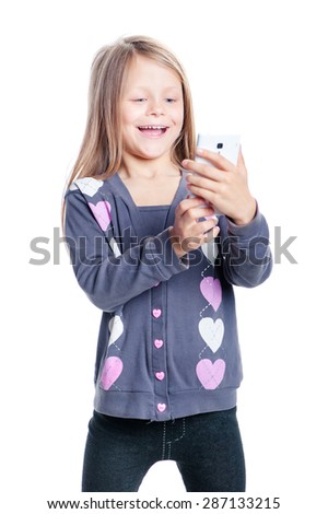 Childhood and technology. Cute little girl using smart phone. Isolated on white.