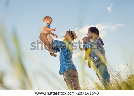 happy family playing outdoors in the park