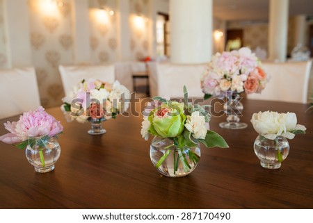 bouquet of flowers in a vase on a brown wood background 