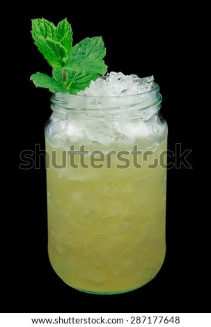 Whiskey smash is a cocktail that contains whiskey, sugar, lemon and mint. Garnished with a mint twig. Isolated on black.