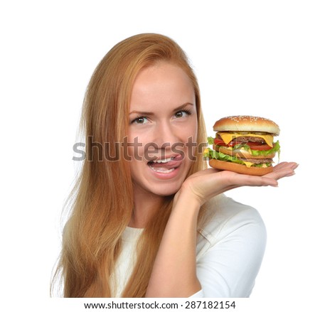 Woman hold tasty unhealthy burger sandwich with cheese salad tomatoes slice and beef in hands hungry getting ready to eat isolated on a white background Fast food concept