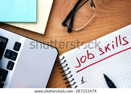 Notepad with words job skills on a wooden background Royalty-Free Stock Photo #287252474