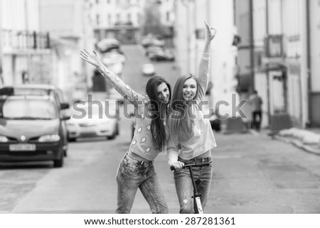 Hipster girlfriends posing in urban city context black and white photo