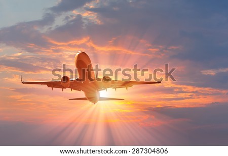 passenger plane fly down over take-off at sunset Royalty-Free Stock Photo #287304806