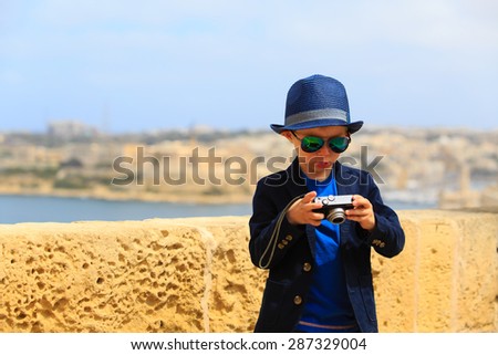 smart little boy taking photos while travel in Europe, Malta
