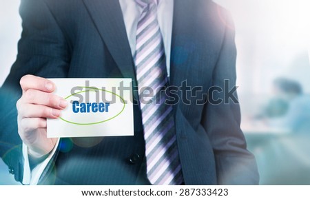 Businessman holding a card with Career written on it.